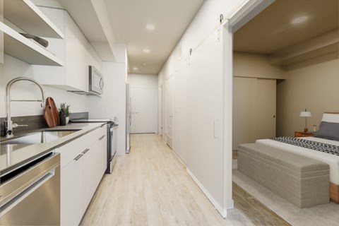 a bedroom with a bed and a sink in a room at Marina Square, Bremerton, WA, 98337